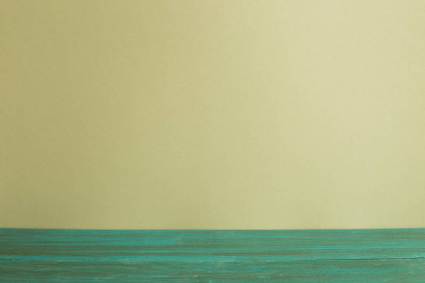Green wooden table top with khaki wall background - Zdjęcie, obraz