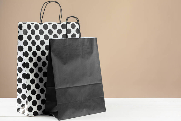 Arrangement of shopping bags on beige background - Фото, изображение