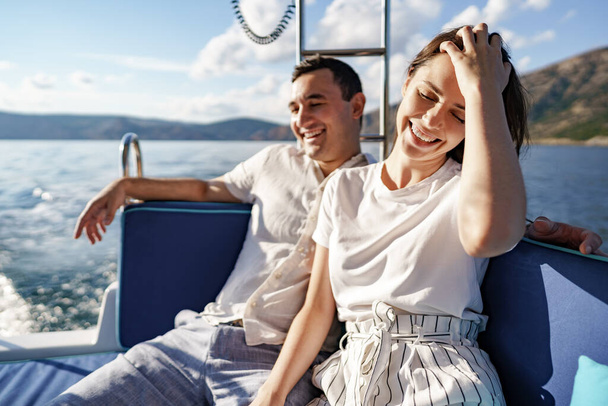 Happy couple on a yacht in summer on romantic vacation - Фото, зображення