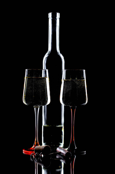 Glasses of wine on a black background. - Φωτογραφία, εικόνα