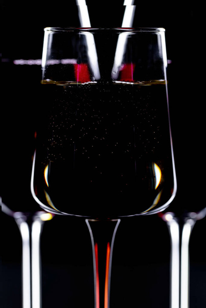 Glasses of wine on a black background. - Foto, Imagen