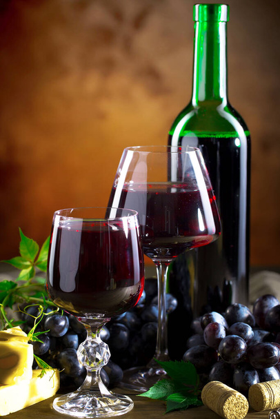 Wine in a glass on an old background - Фото, изображение