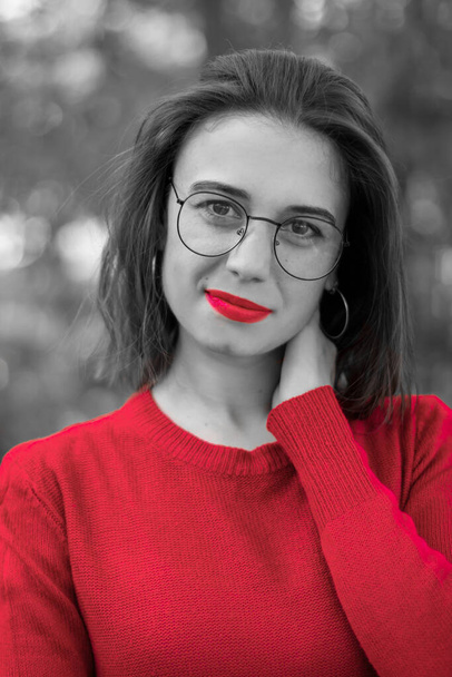 Girl in red sweater in nature. Girl in red in nature. Girl with red lips. Autumn photo, black white with color elements - Foto, Imagen