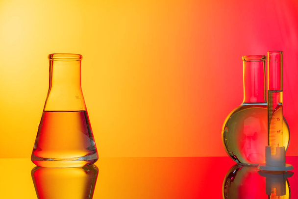 Science concept. Glass test tubes on red background - Foto, Imagen