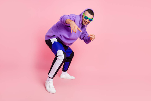 Full length photo of funky young brunet guy dance wear eyewear hoodie pants shoes isolated on pink background - Фото, зображення