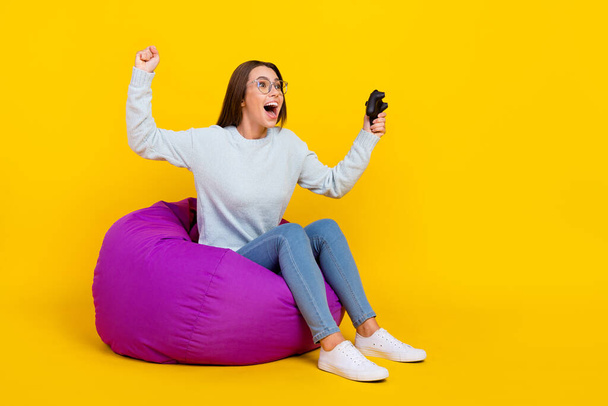 Full length photo of amazed young woman play game winner hold joystick isolated on yellow color background - Foto, Imagem