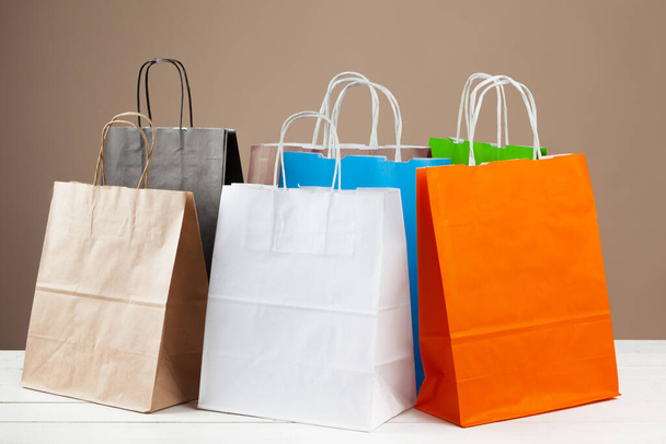 Arrangement of shopping bags on beige background - Foto, afbeelding