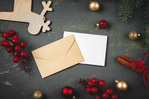 Christmas background with letter, envelope and feather pen surrounded by seasonal decorations - Foto, Imagen