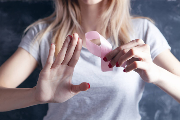 young girl holding a pink ribbon and showing stop - Foto, Imagen