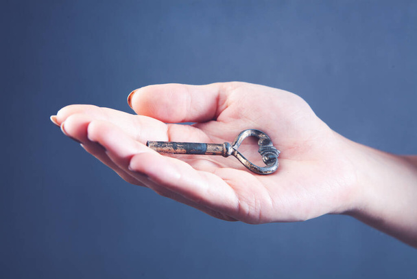 female hand holding an old vintage key - Photo, Image