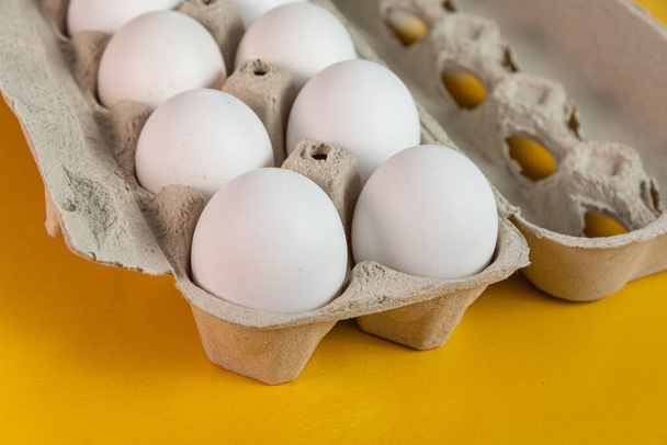 Eggs on the yellow background - Фото, зображення