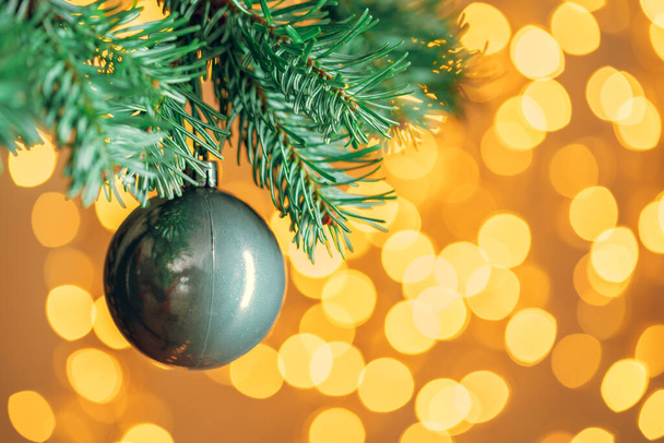 Christmas tree background with grey bauble on golden bokeh sparkling - Φωτογραφία, εικόνα