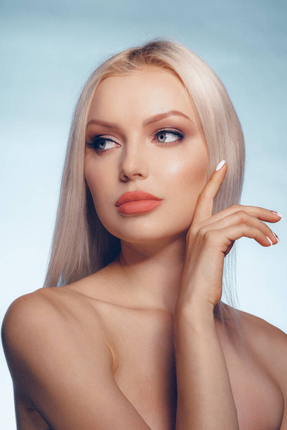 Close up beauty portrait of a blonde woman with perfect skin and plump lips - 写真・画像