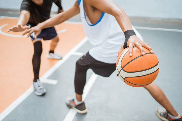 Basketball players hand carrying a ball with a high dribbling technique - Foto, afbeelding