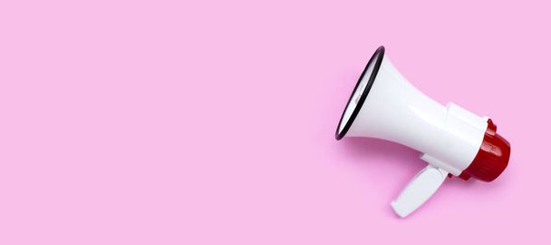 Red and white megaphone on pink background. - Photo, Image