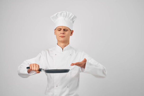 man in chefs clothes frying pan in hands professional kitchen work - Photo, Image