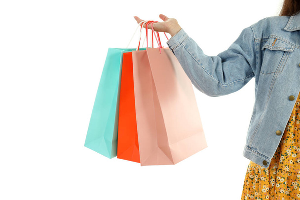 Girl with multicolored paper bags isolated on white background. - 写真・画像