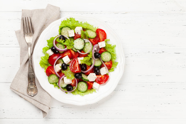 Classic greek salad with fresh garden vegetables. Top view flat lay with copy space - Photo, Image