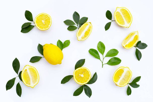 Fresh lemon with green leaves on white background. - Фото, изображение
