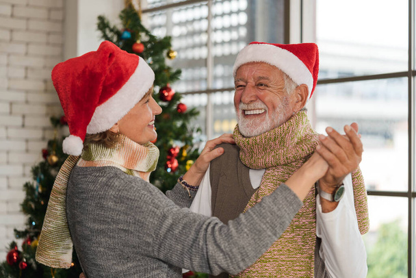 Портрет Кавказького старшого чоловіка має романтичний момент, коли він танцює разом зі своєю дружиною вдома на Різдво і на новорічному святі. Різдвяна і новорічна подружня діяльність. - Фото, зображення