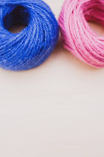 multicolor decoration yarns on a bright wooden background with copy space - Foto, afbeelding
