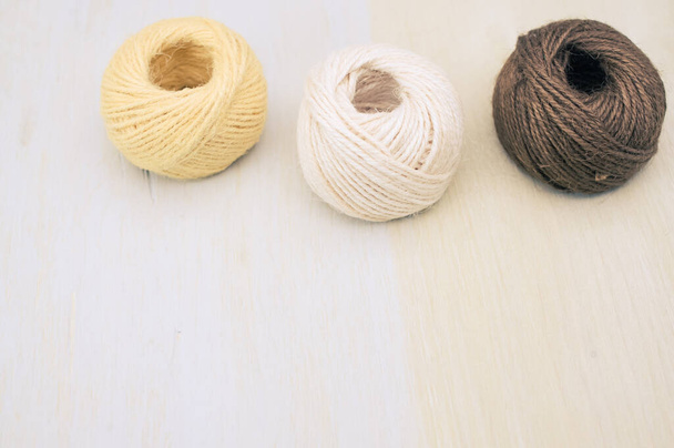 multicolor decoration yarns on a bright wooden background with copy space - Valokuva, kuva