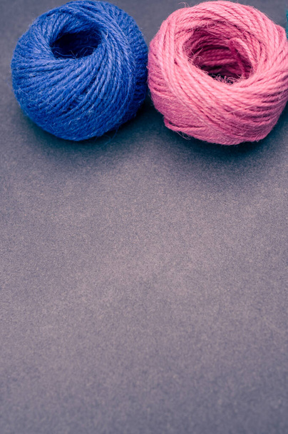 multicolor rough decoration yarns on a dark stone background with copy space - Foto, Bild
