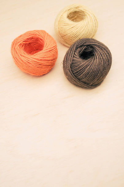 multicolor decoration yarns on a bright wooden background with copy space - Fotó, kép