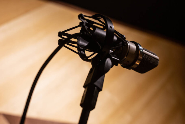 A closeup shot of a black microphone in the studio. - Valokuva, kuva