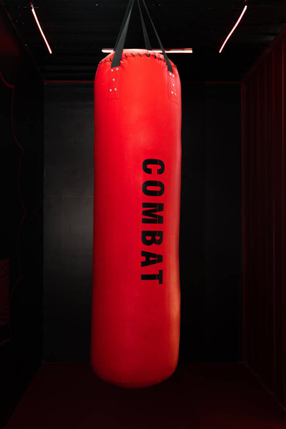 The boxing sandbag with dark background - Фото, изображение