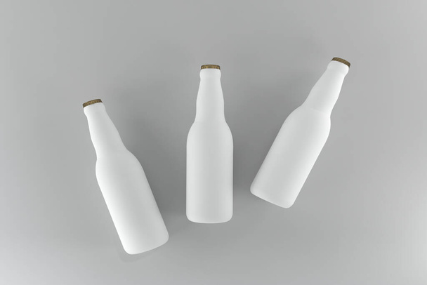 Three white matte beer bottles isolated in the light background - 写真・画像