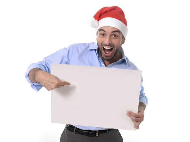 Handsome business man in santa christmas hat pointing blank billboard - Foto, Imagen