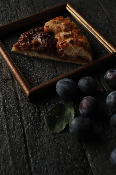 The fresh blackberries and pizza in a frame on a wooden table - Фото, изображение