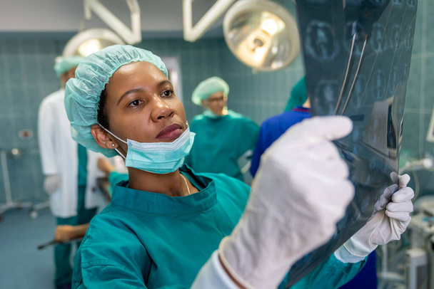 Portrait of successful team of surgeon standing in operating room, ready to work on a patient - Foto, imagen