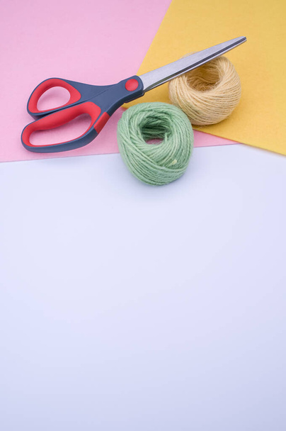multicolor decoration yarns with scissors on a bright wooden background with copy space - 写真・画像