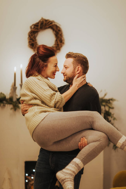 Romantic couple in love feeling happiness about their romance spending christmas eve together, woman and man enjoying perfect relationships - Фото, изображение