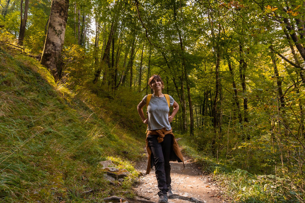 A young woman heading to Passerelle de Holtzarte de Larrau in the forest or jungle of Irati, northern Navarra in Spain and the Pyrenees-Atlantiques of France - Φωτογραφία, εικόνα