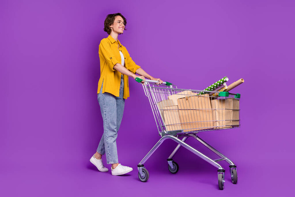 Full length body size view of nice cheery girl going carrying goods art store isolated over bright violet purple color background - Foto, Bild