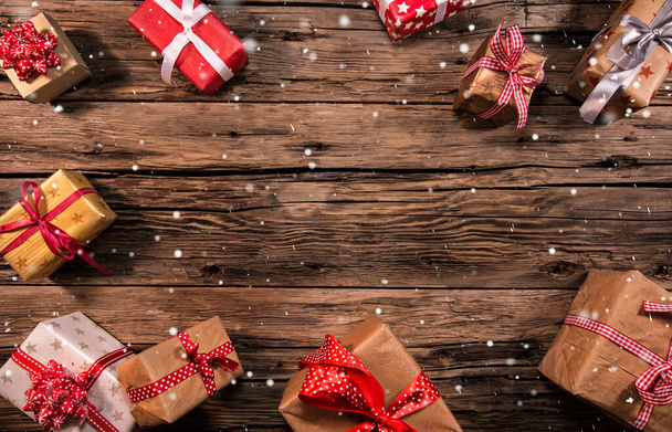 Christmas gifts on wooden background, lots of copy space for product or text. - Фото, зображення