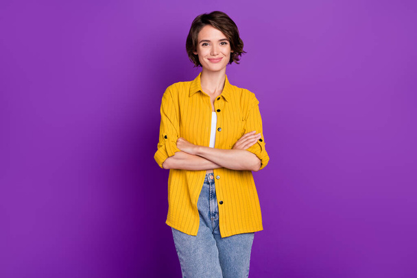Photo of confident charming young lady wear yellow shirt arms crossed smiling isolated violet color background - Fotografie, Obrázek