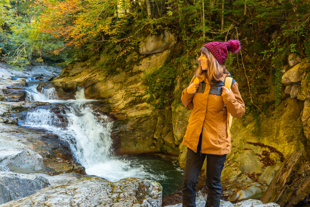 Irati forest or jungle in autumn, a young hiker in the Cubos waterfall. Ochagavia, northern Navarra in Spain - 写真・画像