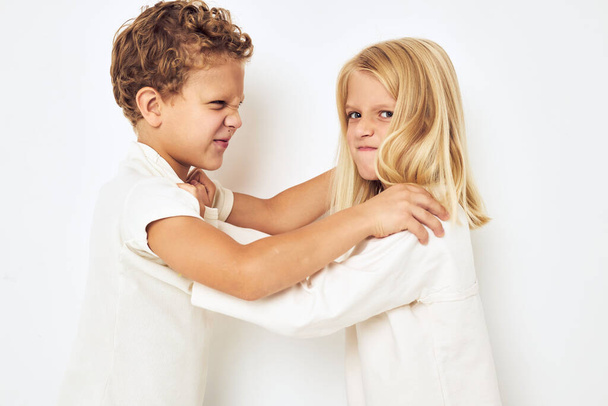 Bad brother sticks to sister quarrel resentment isolated background - 写真・画像