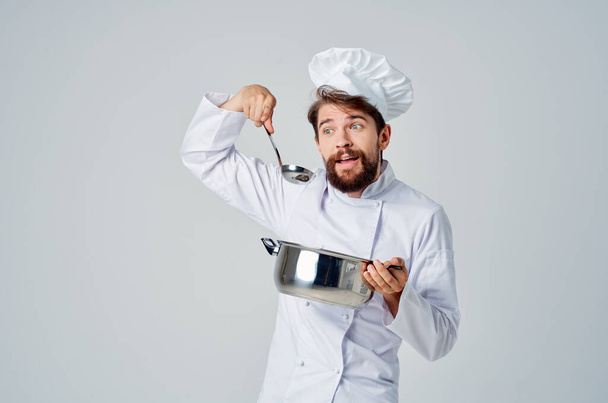 chef with saucepan in hands in kitchen restaurant food preparation service - Photo, Image