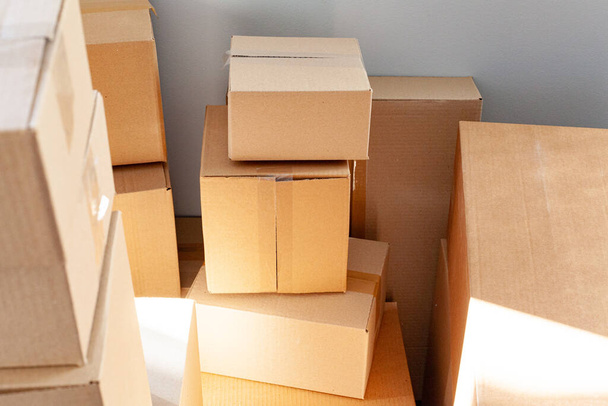 House moving concept with stacked cardboard boxes in a room - Photo, Image
