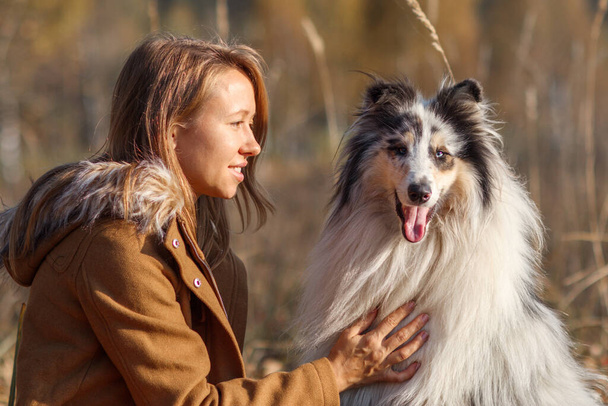 Portrait of Blue Merle Rough Collie and Girl in Autumn Park. - Photo, image