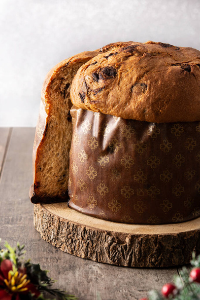 Traditional Italian panettone for Christmas on rustic wooden table - Photo, Image
