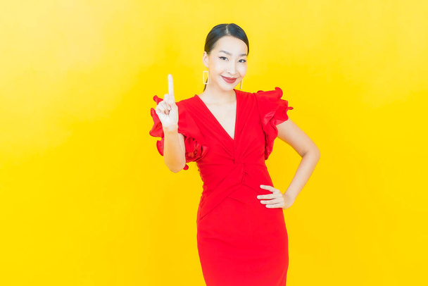 Portrait beautiful young asian woman smile with action on color background - Foto, afbeelding