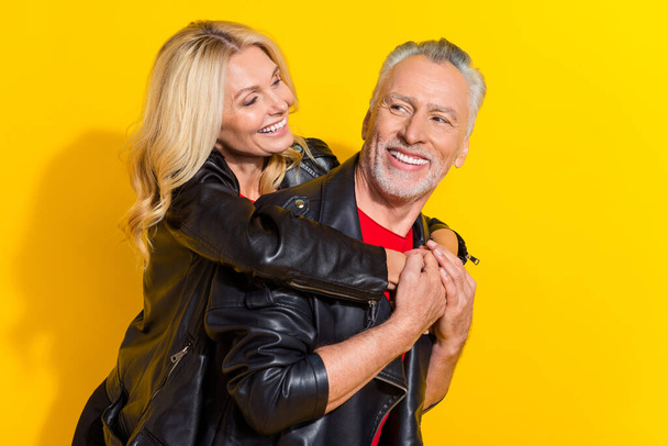 Portrait of attractive cheerful amorous pensioner grey-haired lovers cuddling enjoying isolated over bright yellow color background - Foto, immagini