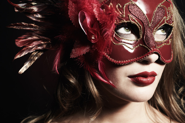 Beautiful young woman in a red mysterious mask - Φωτογραφία, εικόνα