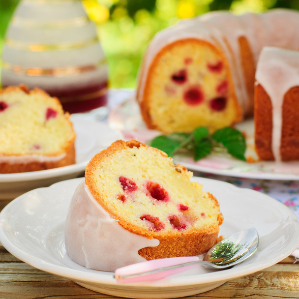 A Slice of Lemon and Caraway Seed Bundt Cake with Raspberries - Photo, Image